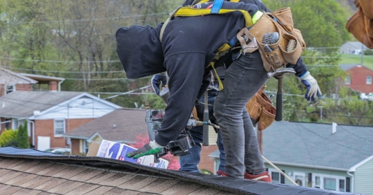 man fixing roof