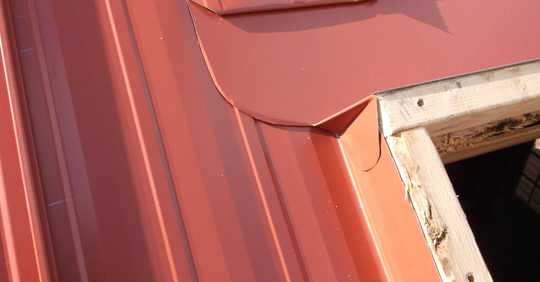 a close up view of a metal roof with a skylight